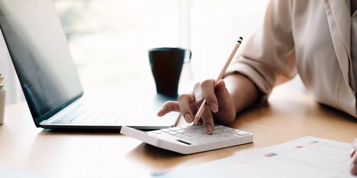 Close up view of bookkeeper or financial inspector hands making report, calculating or checking balance. Home finances, investment, economy, saving money or insurance concept.