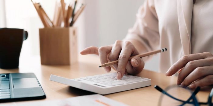 Close up view of bookkeeper or financial inspector hands making report, calculating or checking balance. Home finances, investment, economy, saving money or insurance concept.