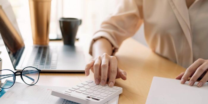 Close up view of bookkeeper or financial inspector hands making report, calculating or checking balance. Home finances, investment, economy, saving money or insurance concept.