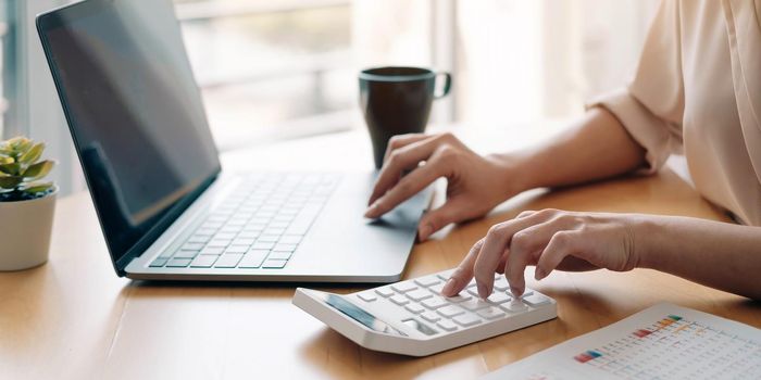 Close up view of bookkeeper or financial inspector hands making report, calculating or checking balance. Home finances, investment, economy, saving money or insurance concept.