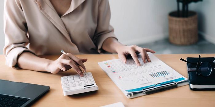 Close up view of bookkeeper or financial inspector hands making report, calculating or checking balance. Home finances, investment, economy, saving money or insurance concept.