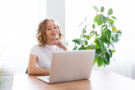Business woman using laptop sitting near desk white office interior with houseplant looking a side Business people Business person Online, Young and successful Dresed white shirt