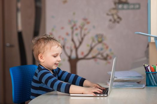 Cute baby boy having video class or video chat with grandparents. Quarantine isolation distance communication concept