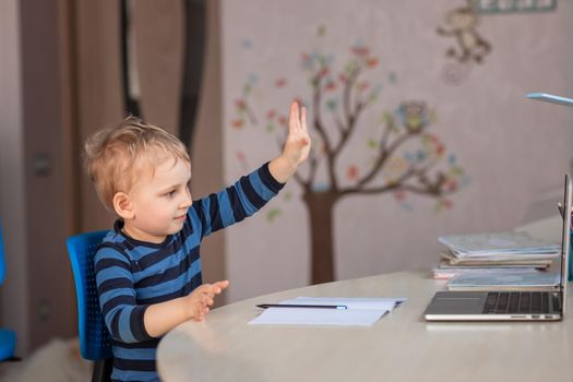 Cute baby boy having video class or video chat with grandparents. Quarantine isolation distance communication concept