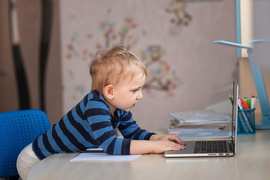 Cute baby boy having video class or video chat with grandparents. Quarantine isolation distance communication concept