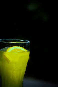 Orange soda in a crystal glass with a piece of natural orange. No people