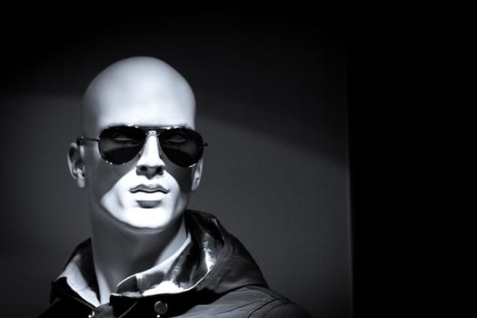 Portrait of a male mannequin with sunglasses. Copy space