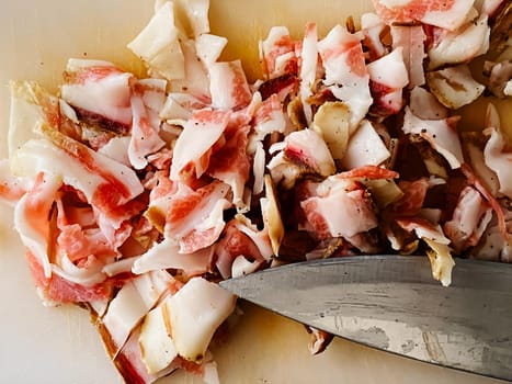 Guanciale cut into small pieces to season the carbonara pasta. Typical Italian food. Pork cheek. Meat and seasoning