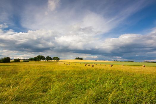 Harvest time and summer landscape after a storm