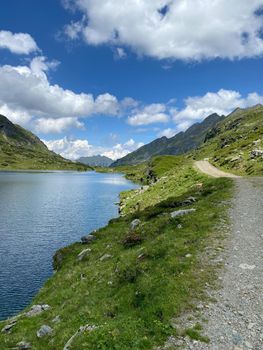 Footpath on the shore of the Lake Giglachsee in the Styrian Tauern - Austria. Lake Giglachsee in the Styrian Tauern - Austria. The place without  tourists after the coronavirus pandemic.