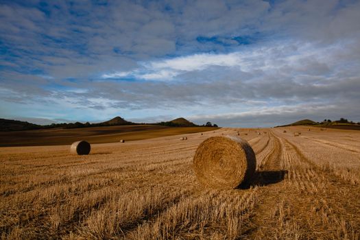 Straw bales on a stubble in Central Bohemian Uplands, Czech Republic. Field landscape bales of straw on a farm field