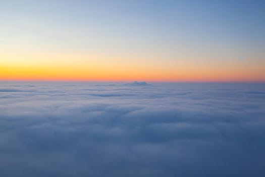 Amazing sunrise above clouds from the top of the mountain in Central Bohemian Uplands, Czech Republic