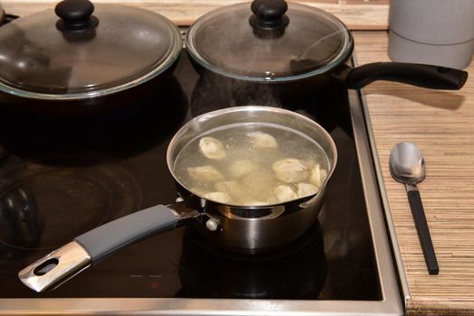 Russian Dumplings in boiling water. Meat dumplings are boiled in a pot of boiling water.