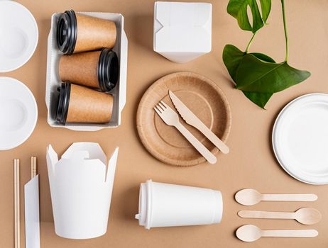 Knolling concept. Eco friendly zero waste disposable tableware top view flat lay on brown background