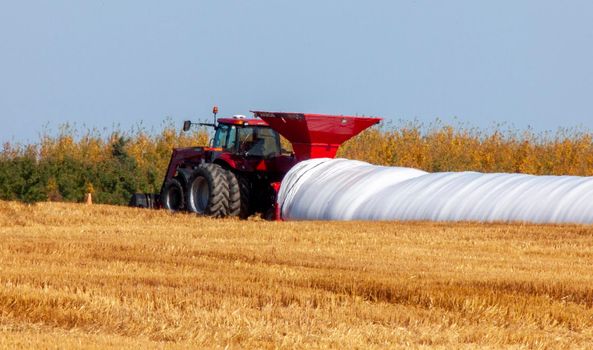 Grain Bag Saskatchewan tractor filling crop Canada