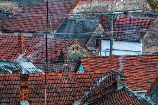 Overview of tile rooftops of old houses. Old buildings architecture.