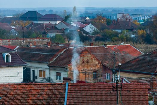 Overview of tile rooftops of old houses. Old buildings architecture.