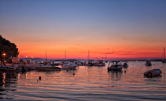 Boats and yachts in marina during sunset