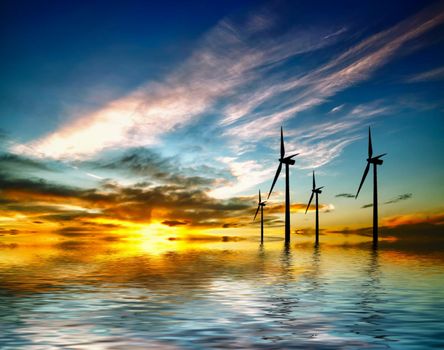 Wind turbines silhouette at sunset