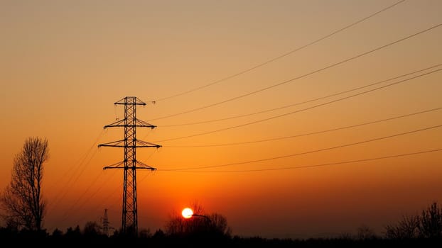 Metal electric pole at sunset