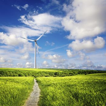 Wind turbine on a farm in cloudy skies