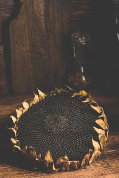 Dry sunflower head on the wooden table