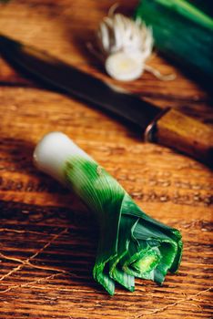 Fresh green leek on rustic wooden table