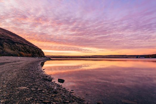 Autumn sunrise on the hilly coast of Zay river