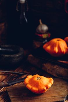 Yellow pattypan squash on cutting board in rustic setting