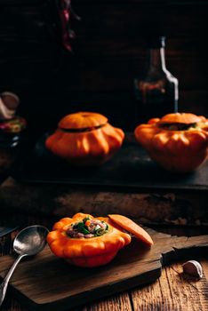 Stuffed pattypan squash ready to cooking on cutting board