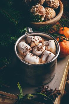 Cup of hot chocolate with marshmallows on old books