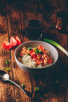 Scrambled eggs with tomatoes, leek and white rice. Turkish coffee and sliced ingredients.