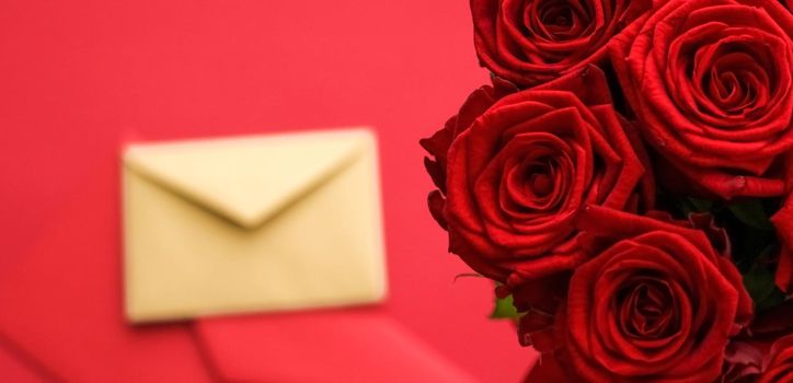 Holiday gift, flowers flatlay and happy relationship concept - Love letter and flower delivery service on Valentines Day, luxury bouquet of red roses and card envelopes on red background