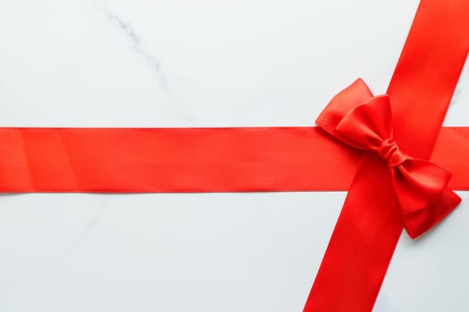 Holiday decor, feminine design and flatlay concept - Red silk ribbon on marble, top view