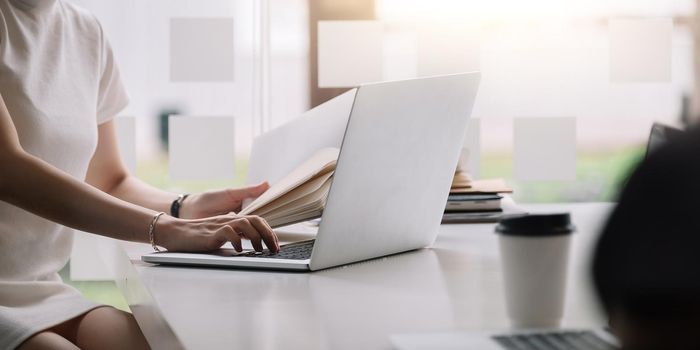 Businesswoman working on computer at table in office, closeup. Banner design.