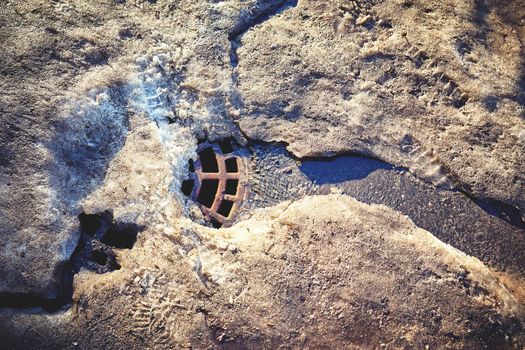 Contaminated the snow melts against the background of the drain into the storm sewer. Ecological problems