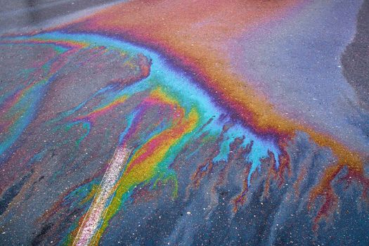 Oil stain on Asphalt, color Gasoline fuel spots on Asphalt Road as Texture or Background