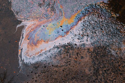Oil stain on Asphalt, color Gasoline fuel spots on Asphalt Road as Texture or Background