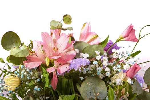 Beautiful bouquet of natural flowers close up on a white background. Selective focus