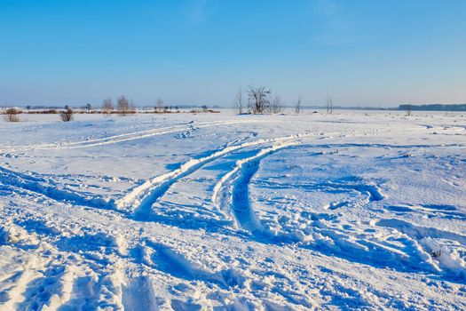 Car tire tracks on snow close up