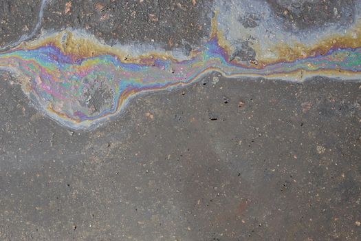 Oil stain on Asphalt, color Gasoline fuel spots on Asphalt Road as Texture or Background