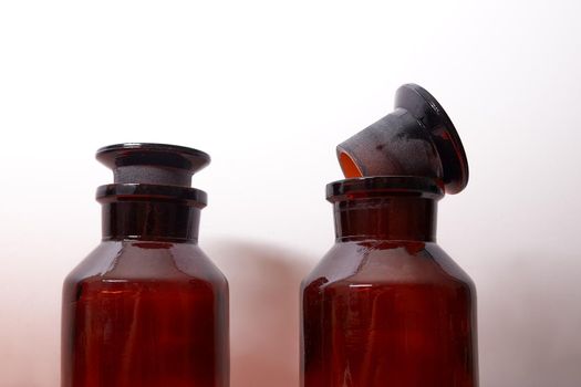 bottles for chemicals with dark glass on a white background