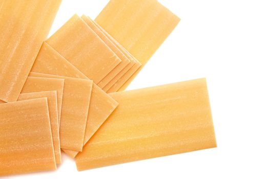 Pile of dried lasagna pasta sheets isolated over the white background