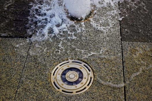 Water splashes in the evening in the city fountain close up.Selective focus