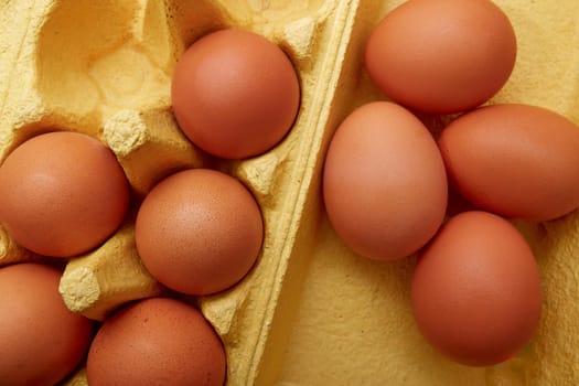 Brown chicken eggs on tray background. View from above