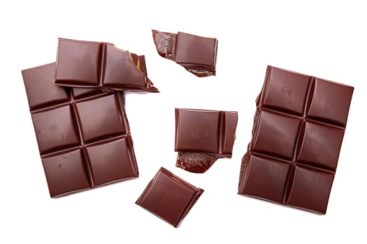 Dark chocolate bar and cubes isolated on white backgroun, top view