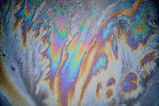 Beautiful abstract colorful background, texture, stains from engine oil on the asphalt.Colorful gas stain on wet asphalt