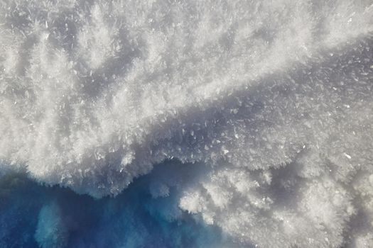 Snow texture background, natural white snow powder in winter on a bright sunny day