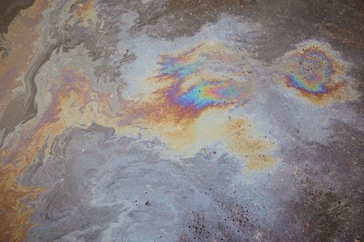 Beautiful abstract colorful background, texture, stains from engine oil on the asphalt.Colorful gas stain on wet asphalt