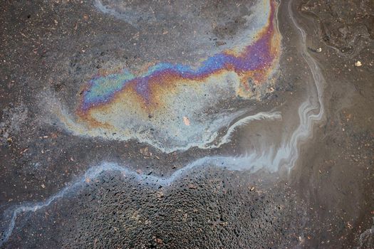 Abstract background with oil stain of oil products.Oil stain on Asphalt, color Gasoline fuel spots on Asphalt Road as Texture or Background.